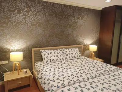 Cozy bedroom with floral wallpaper and modern lighting
