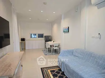 Modern living room with cozy sofa and dining area in open layout