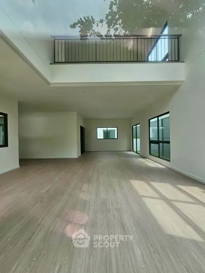 Spacious modern living room with high ceilings and large windows, perfect for natural light.