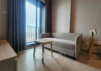 Modern living room with cozy sofa and balcony view