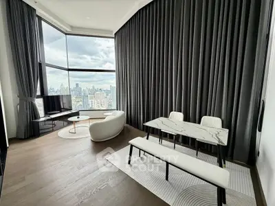 Luxurious modern living room with panoramic city views and elegant furnishings.