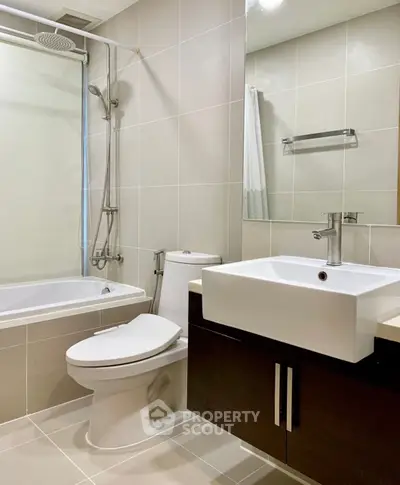 Modern bathroom with sleek fixtures and bathtub in contemporary apartment.