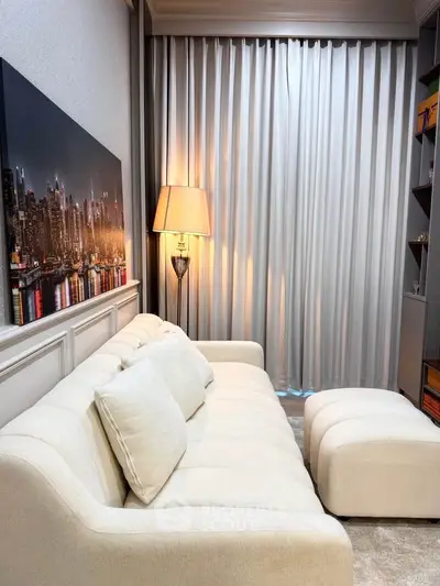 Elegant living room with plush white sofa and cityscape artwork, perfect for modern urban living.