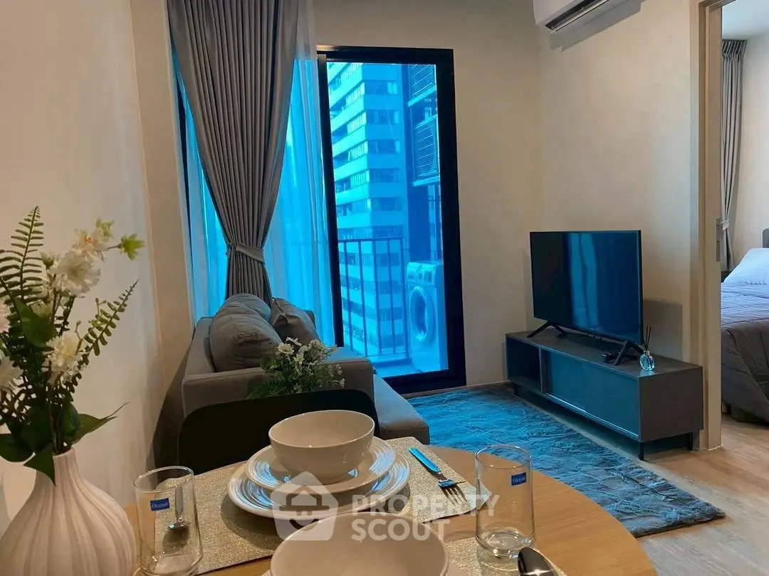 Modern living room with balcony view and stylish decor in urban apartment.