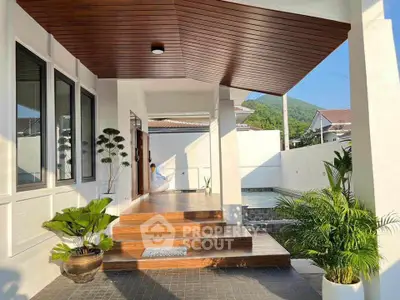 Stunning modern entrance with wooden accents and lush greenery