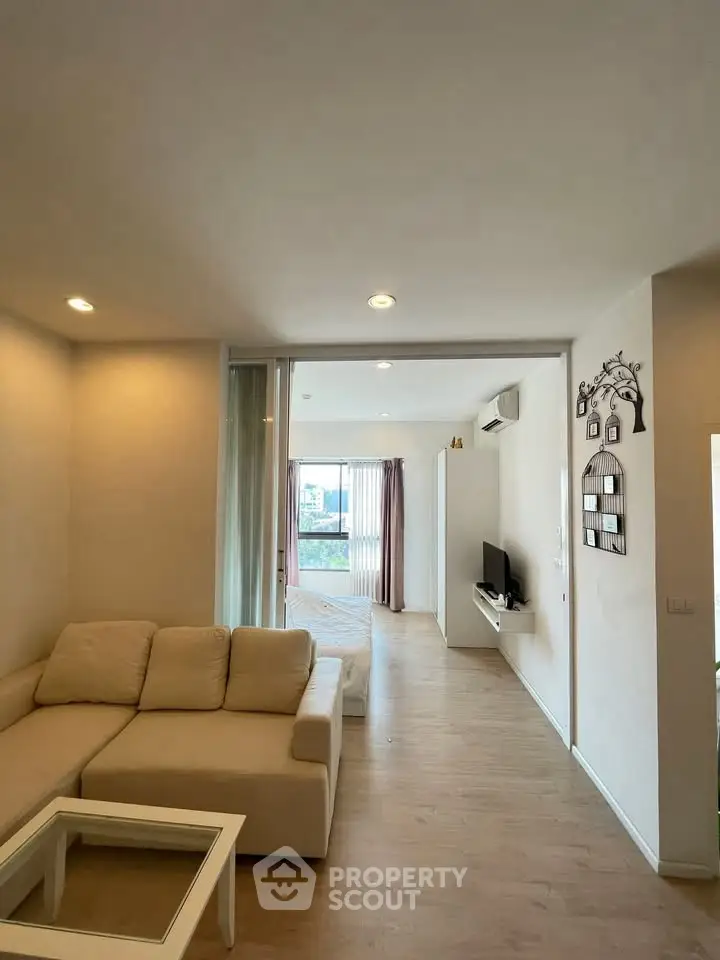 Modern open-plan living room with cozy sofa and natural light