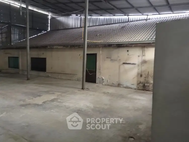 Spacious industrial warehouse with high ceiling and ample storage space.