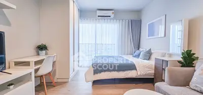 Modern bedroom with stylish decor, featuring a cozy bed, study desk, and large window with city view.