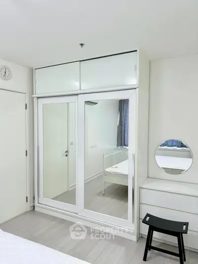 Modern bedroom with mirrored wardrobe and minimalist decor