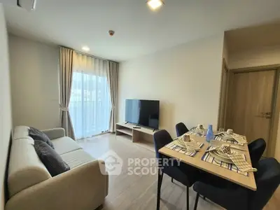 Modern living room with dining area, featuring a cozy sofa and elegant dining setup.