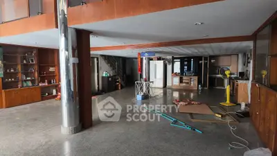 Spacious open-plan living area with modern design and ample natural light, perfect for versatile use.