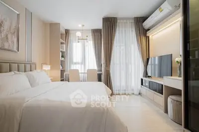 Modern bedroom with elegant decor, large window, and stylish furniture in a cozy apartment.