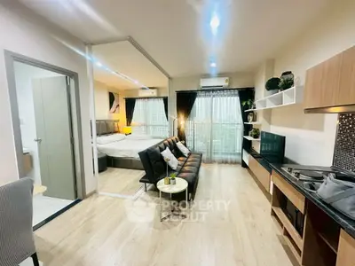 Modern studio apartment with open layout, featuring cozy living area and stylish kitchen.