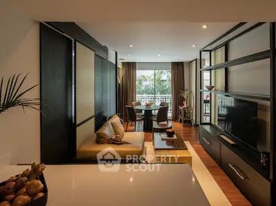 Luxurious living room with modern decor and large windows overlooking greenery, perfect for relaxation.