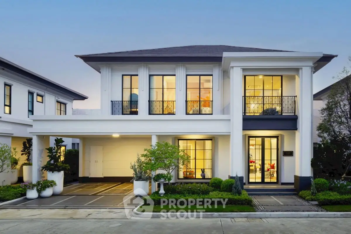 Elegant two-story house with modern architecture and lush landscaping.