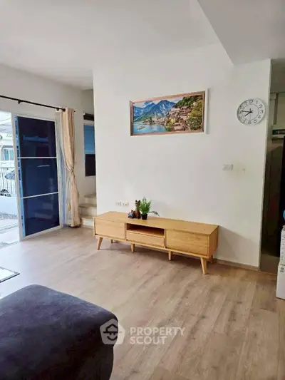 Spacious living room with modern decor and large window view