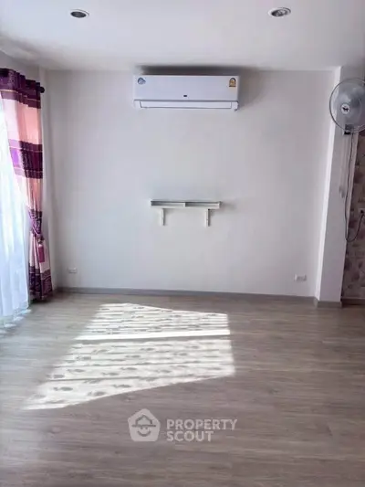Spacious empty room with air conditioning and natural light, perfect for customization.