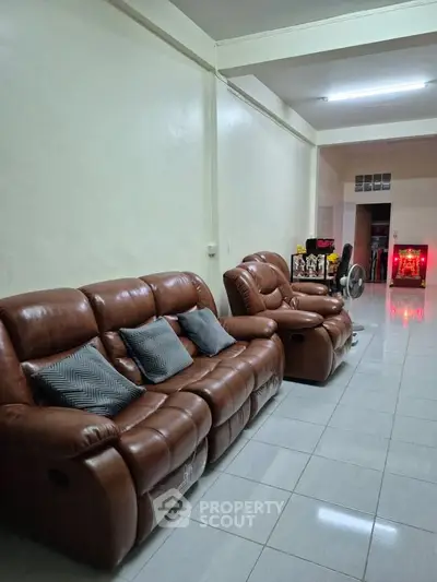 Spacious living room with leather sofas and modern decor