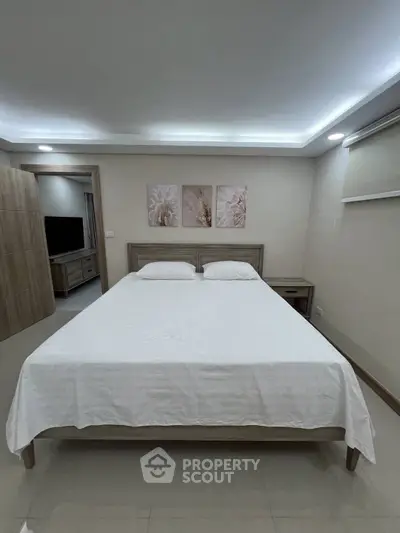 Spacious bedroom with modern decor and cozy ambiance