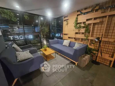 Cozy modern living room with stylish blue sofas and greenery accents.