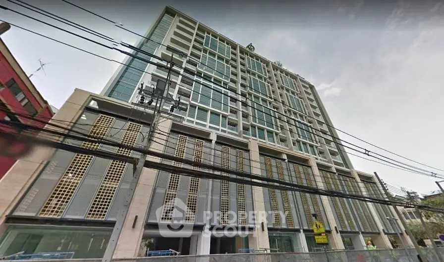 Modern multi-story building with sleek design and large windows in urban setting.