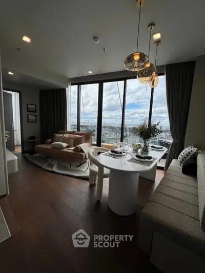 Luxurious living room with panoramic city view, elegant decor, and modern furniture in a high-rise apartment.