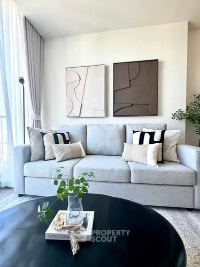 Modern living room with stylish sofa and abstract art, perfect for contemporary home decor.