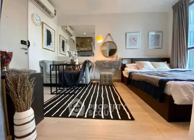 Stylish modern bedroom with cozy seating area and elegant decor