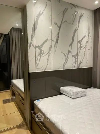 Modern bedroom with marble accent wall and sleek design