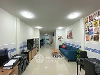 Spacious modern living room with stylish decor and ample natural light, perfect for relaxation and entertainment.