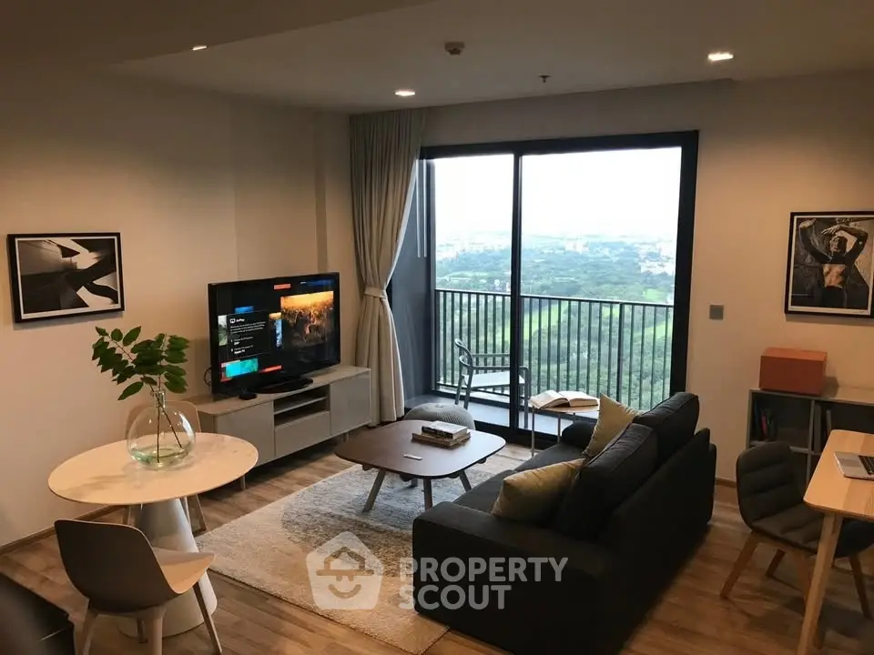 Modern living room with balcony and scenic view, stylish furniture, and cozy ambiance.
