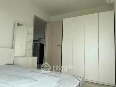 Modern bedroom with white furniture and spacious wardrobe