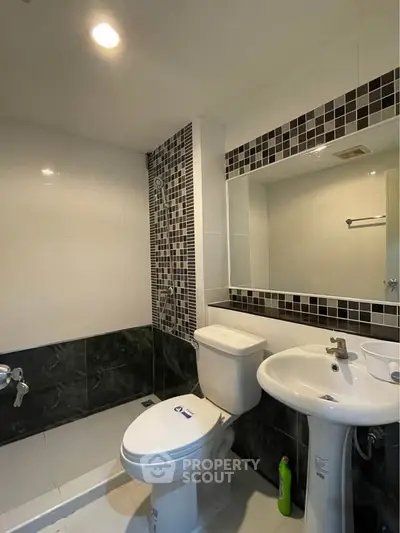 Modern bathroom with sleek fixtures and stylish tile accents, perfect for a contemporary home.