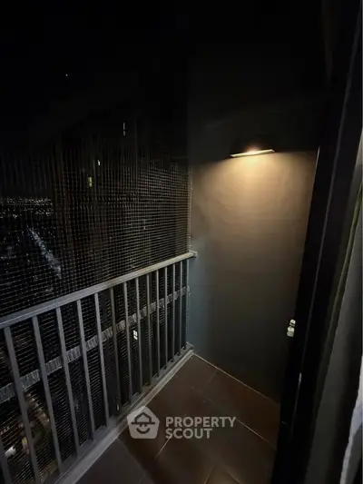 Cozy balcony with night lighting and city view, perfect for relaxation.