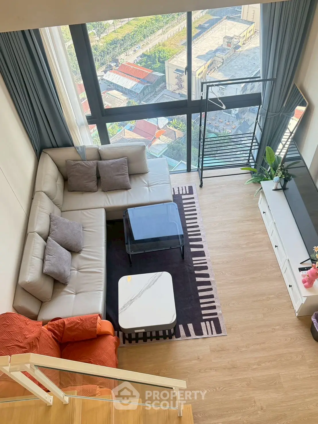 Spacious living room with modern decor and large windows offering a stunning view.