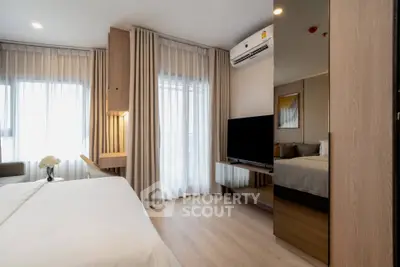 Modern bedroom with sleek design, featuring large windows, stylish furniture, and ambient lighting for a cozy atmosphere.