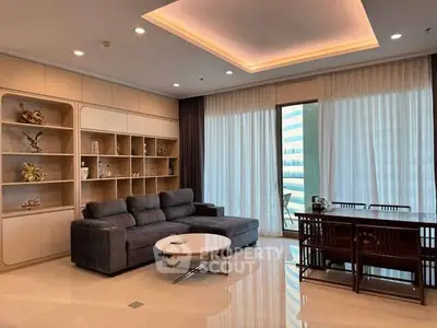 Luxurious living room with modern sofa, elegant shelving, and large windows offering stunning views.