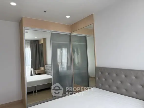 Modern bedroom with sleek wardrobe and stylish headboard