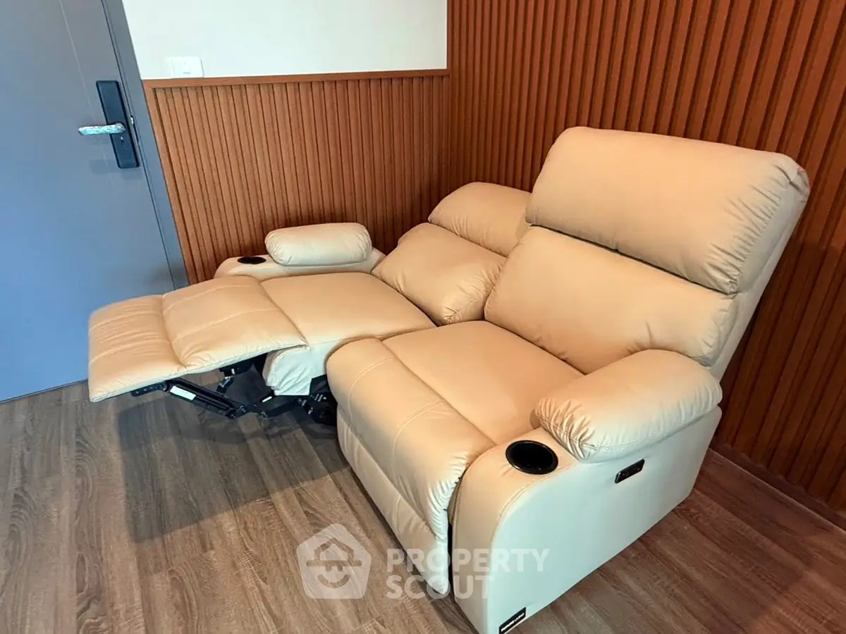Luxurious beige recliner in modern living room with wooden paneling