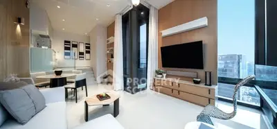 Modern living room with large windows and stylish decor in a high-rise apartment.
