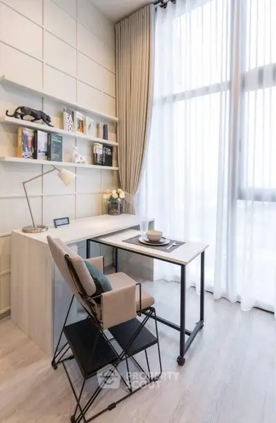 Modern study room with sleek desk, stylish chair, and floor-to-ceiling windows for natural light.