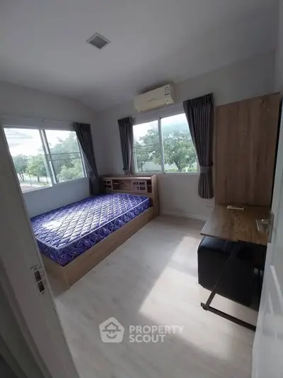 Bright and airy bedroom with large windows and modern furnishings