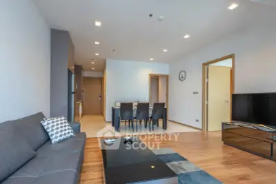 Spacious modern living room with sleek furniture and open dining area