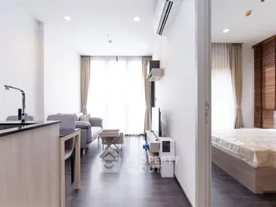 Modern open-plan living room with sleek design and natural light