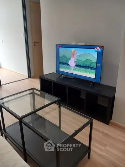 Modern living room with sleek TV stand and glass coffee table