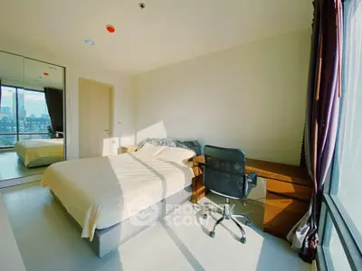 Bright and modern bedroom with city view, featuring a comfortable bed and sleek workspace.