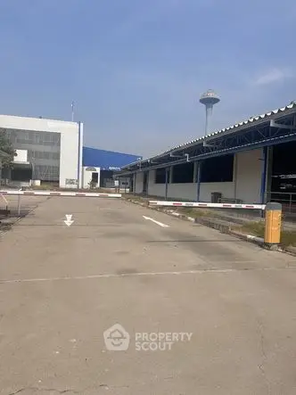 Industrial property with spacious exterior and secure gated entrance
