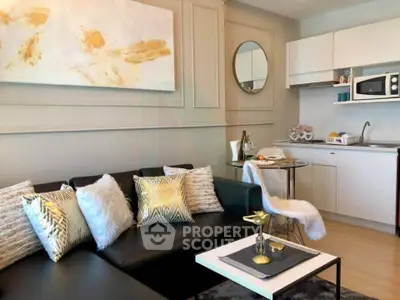 Stylish modern living room with chic decor and compact kitchen area, perfect for urban living.