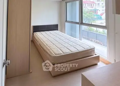 Bright bedroom with large windows and minimalist design in modern apartment.