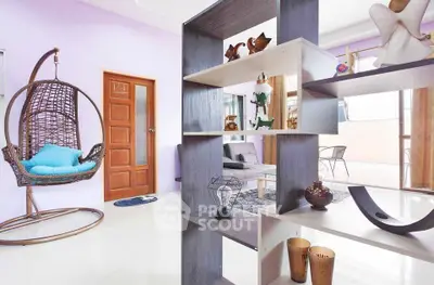 Modern living room with unique decor and hanging chair, bright and inviting space.